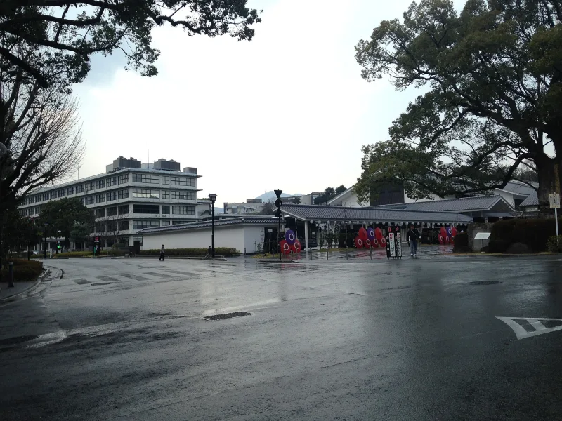 Entrance area of Sakuranobaba Josaien with red banners, near Kumamoto Castle