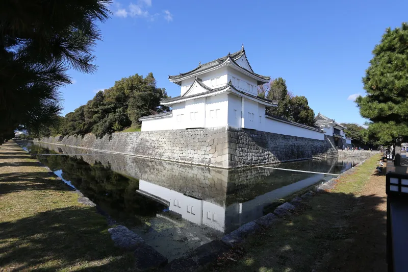 White corner turret of Nijo Castle reflected in the moat