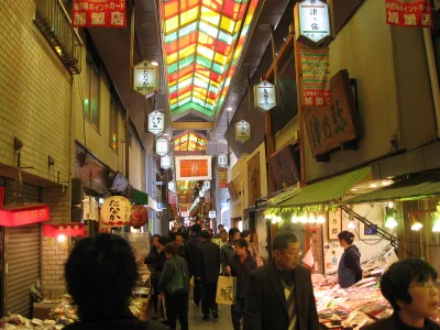 Shoppers under the colourful arcade roof of Nishiki Market in Kyoto