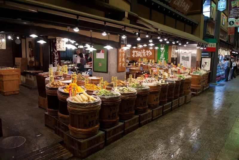 Barrels of Kyoto pickles displayed in front of a shop in Nishiki Market