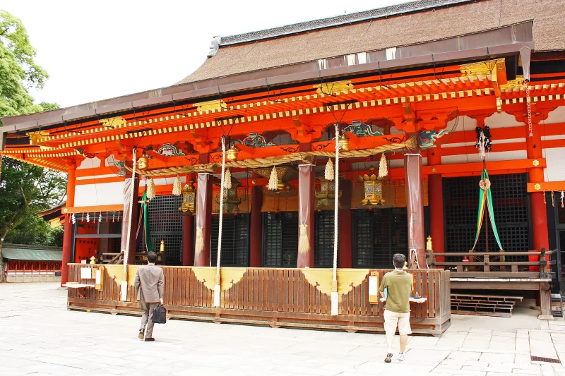 Front of Yasaka Shrine's main hall with hanging lanterns and bells