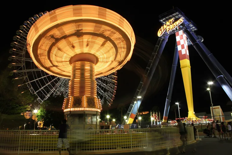 Illuminated swing carousel and pendulum ride at Nagashima Spa Land at night