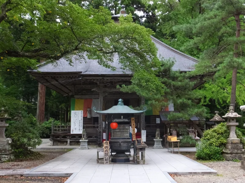 The Akiu Otaki Fudoson temple hall with incense burner, next to the falls