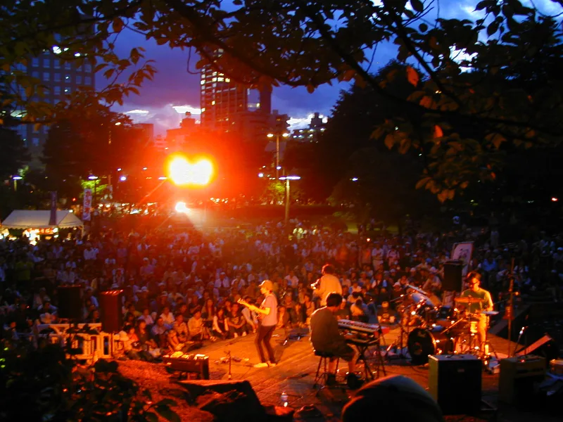 Evening crowd watching a band on an outdoor stage during the Jozenji Streetjazz Festival in Kotodai Park