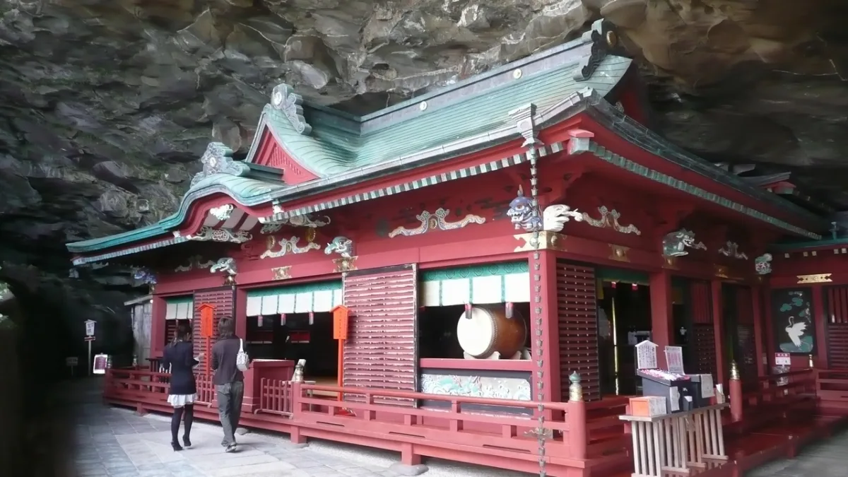 Vermilion main hall of Udo Jingu built inside a seaside cave