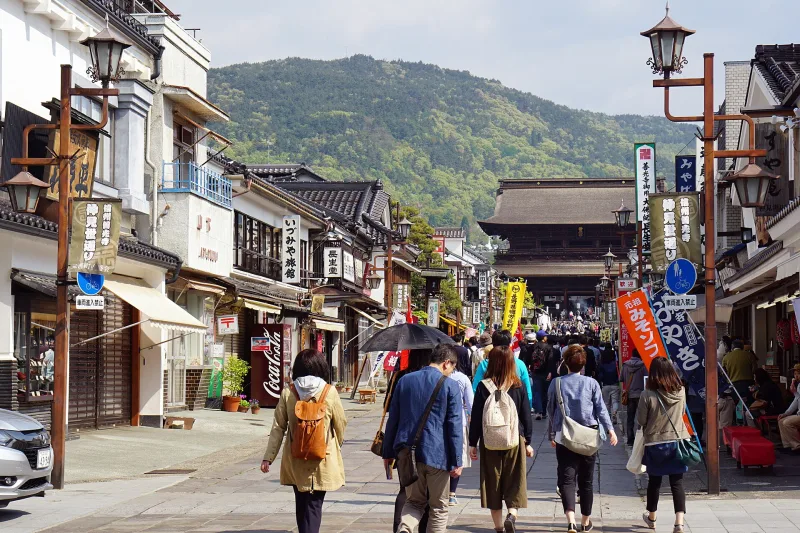 Nakamise-dori, the stone-paved shopping street leading up to Zenko-ji, lined with shops