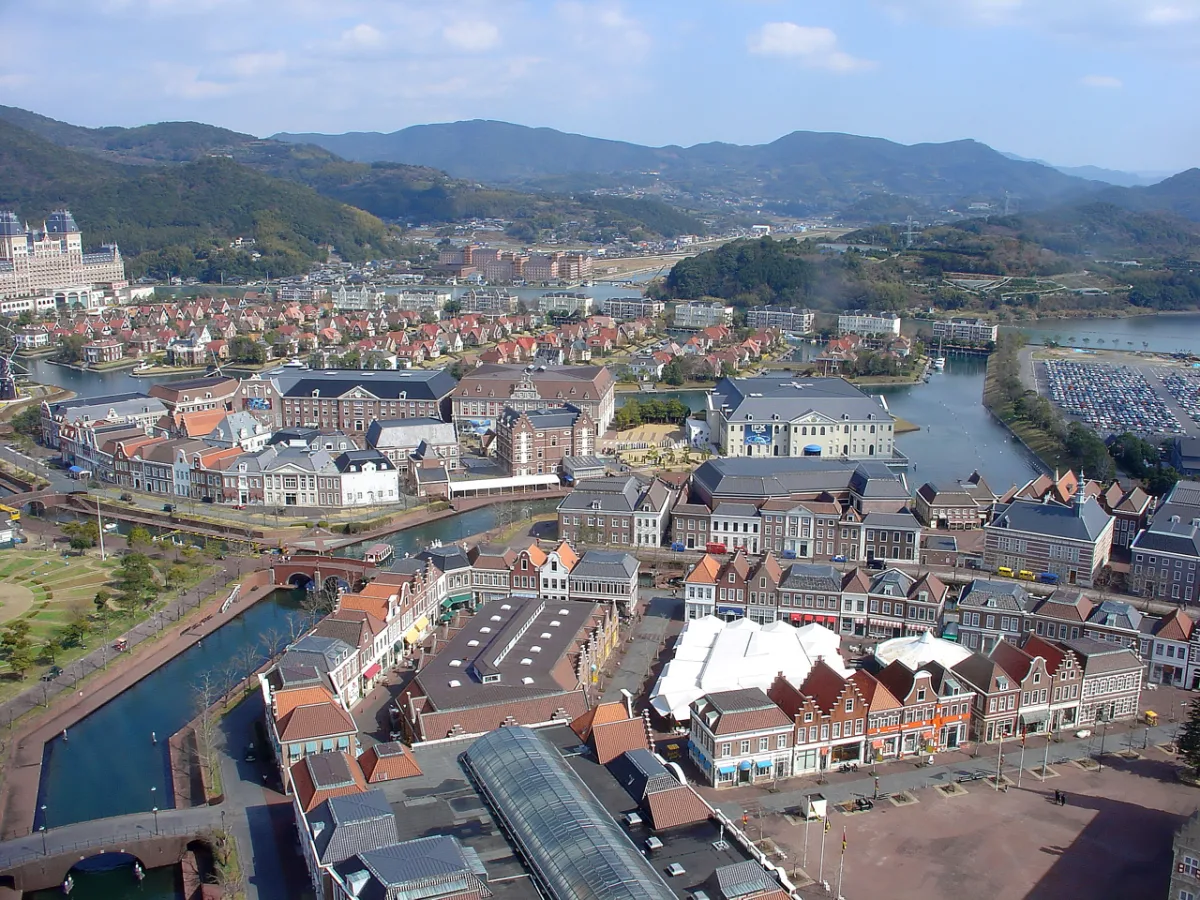 Aerial view of Huis Ten Bosch with Dutch-style brick buildings, canals and the sea