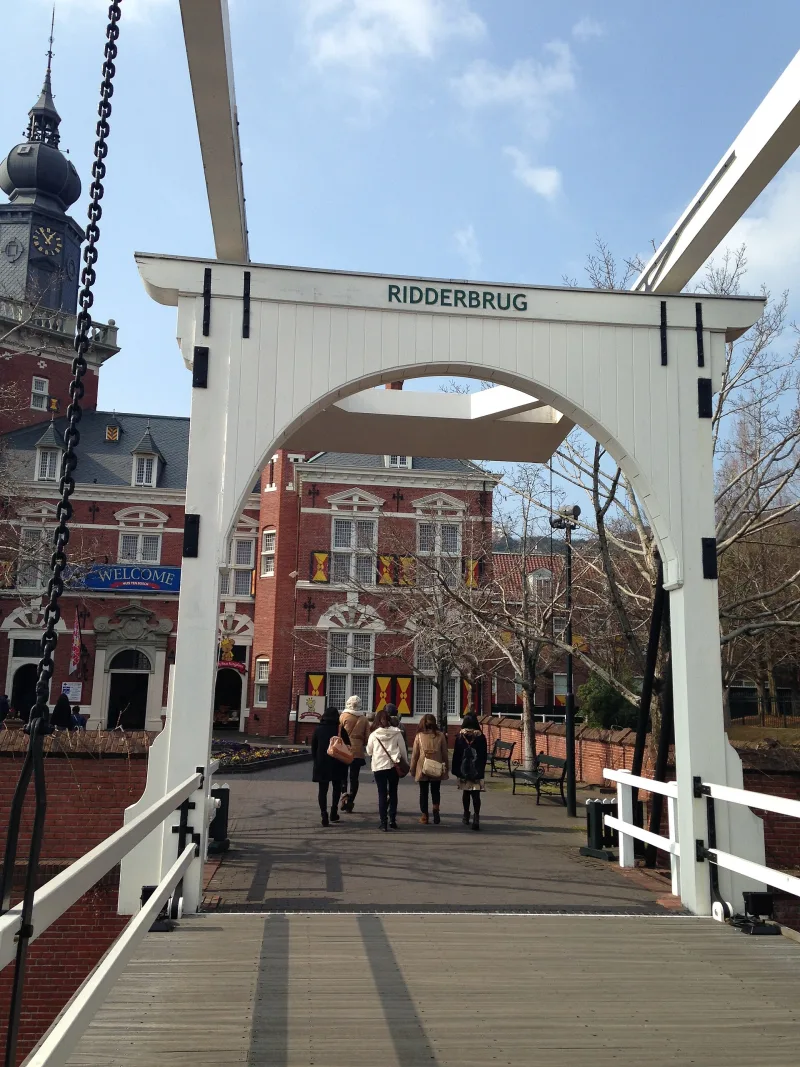 White Dutch-style drawbridge over a canal in Huis Ten Bosch