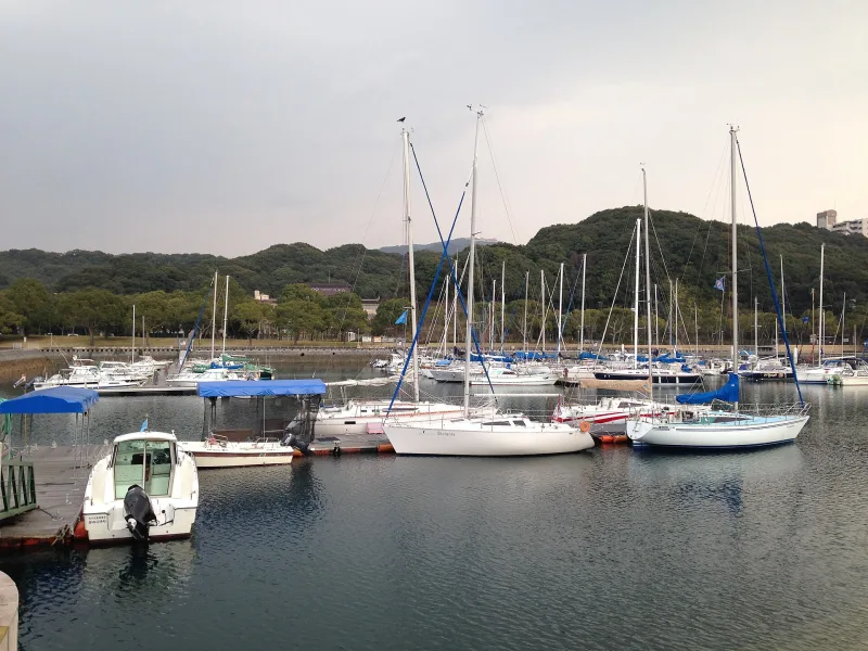 Yachts in the marina with wooded Kujukushima islands behind