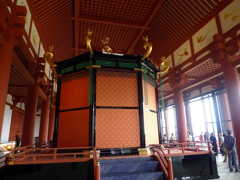 Inside the Daigokuden hall with a throne-like structure and red pillars