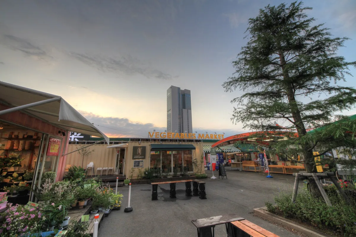 Market stalls and terrace at Pia Bandai in Niigata, with the Bandaijima Building behind