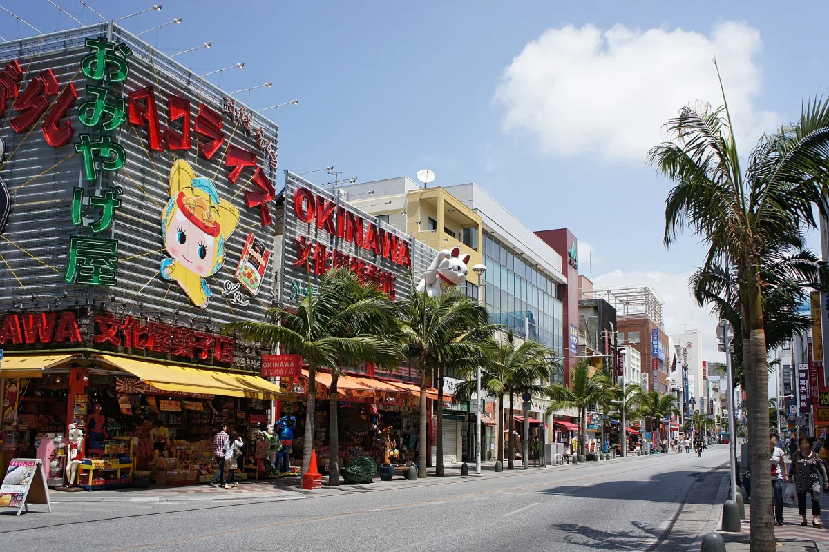 Kokusai-dori in Naha with palm trees, souvenir shops and colourful signs