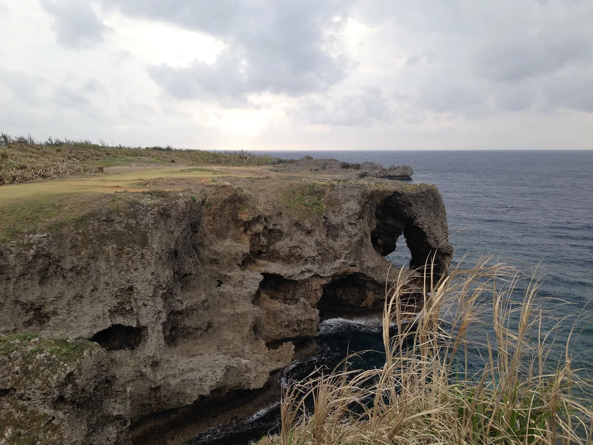 The elephant-trunk shaped limestone rock arch at Cape Manzamo above the East China Sea