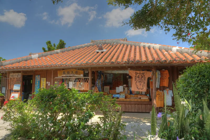 A red-tiled traditional Okinawan house used as an indigo dye studio at Okinawa World