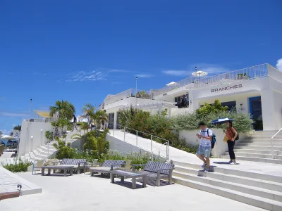 White terraced buildings and stairways of Umikaji Terrace on Senaga Island under a blue sky