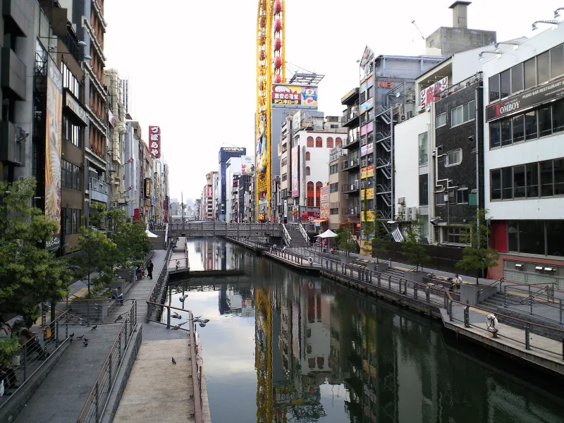 The Dotonbori canal and Tombori River Walk lined with buildings and signs