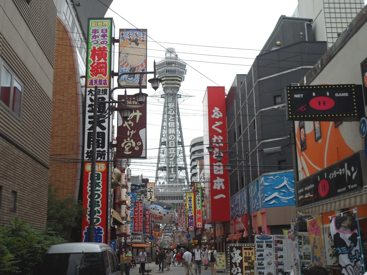 Tsutenkaku Tower rising above the colourful shop signs of Shinsekai, Osaka
