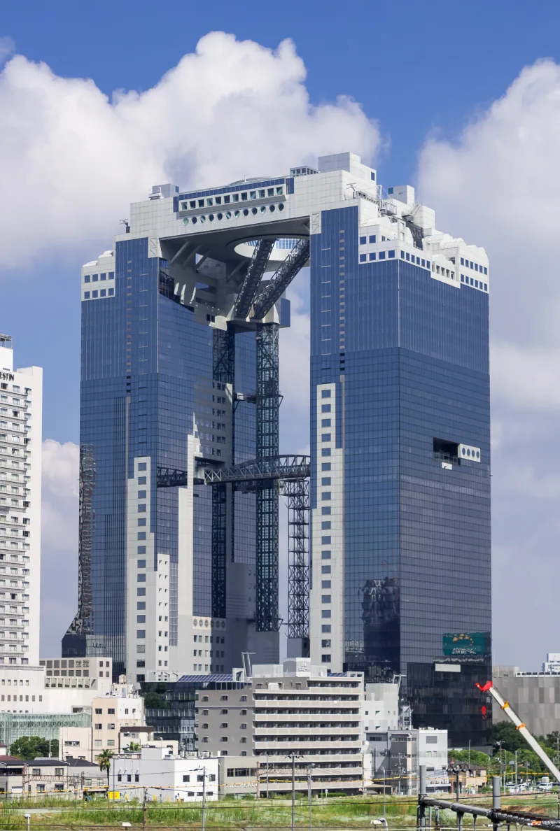 The twin towers of the Umeda Sky Building linked at the top, seen from a distance