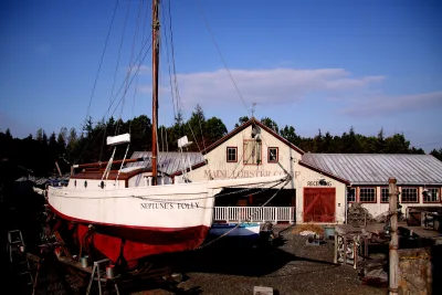 A fishing boat and seaside village buildings in the Amity Village area of Universal Studios Japan