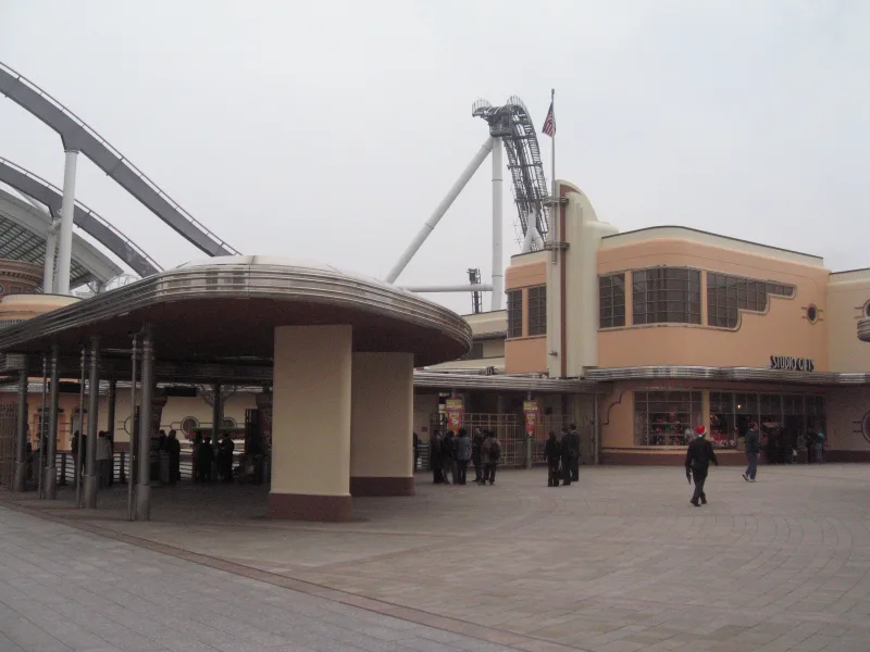 Universal Studios Japan entrance area with a roller coaster track rising behind the buildings