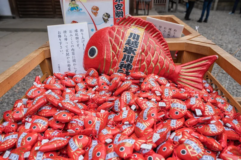 A basket of small red sea-bream-shaped omikuji fortunes at Kawagoe Hikawa Shrine