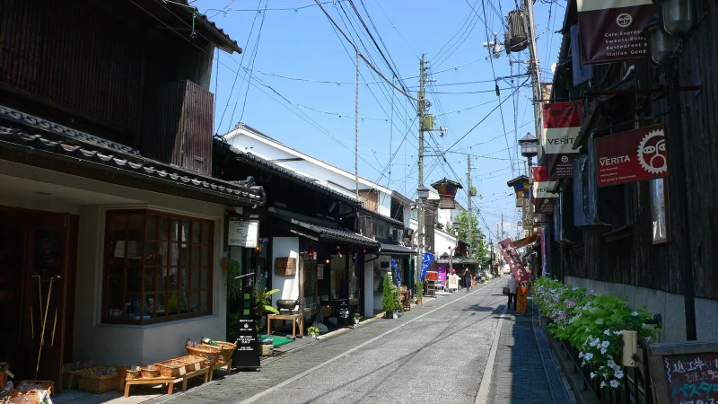 Narrow street of old merchant houses with shops and flowers in Kurokabe Square