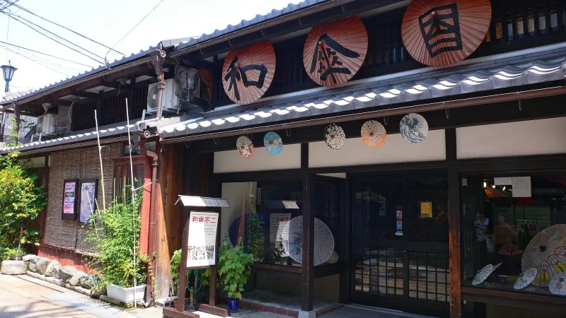 Traditional shop front decorated with Japanese umbrellas in Kurokabe Square