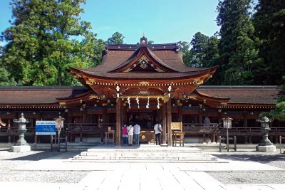 Front of the vermilion-trimmed main worship hall of Taga Taisha under a blue sky