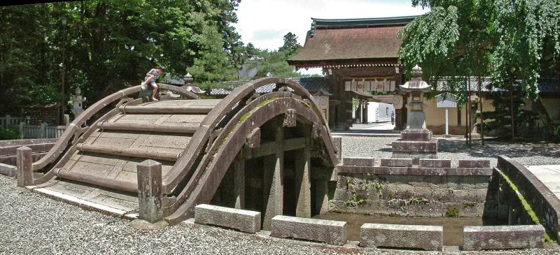 The steep arched stone Taiko Bridge at the entrance of Taga Taisha