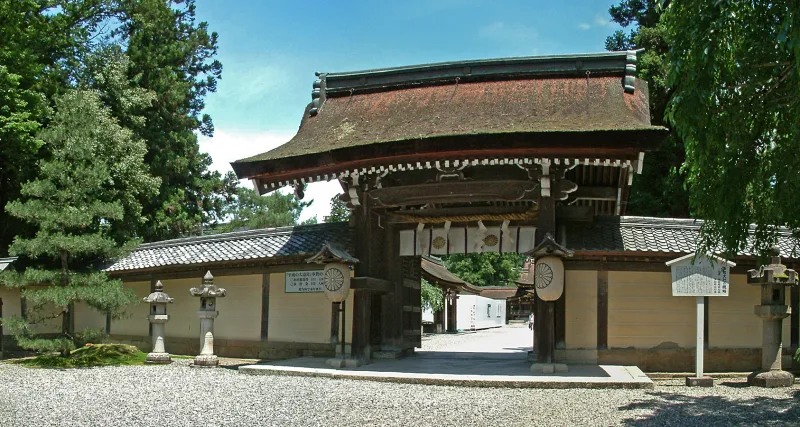 Wooden gate with a curved roof inside the grounds of Taga Taisha