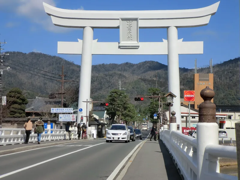 Giant white concrete torii gate over the road leading to Izumo-taisha