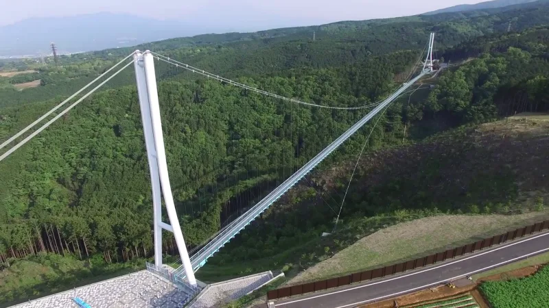 Aerial view of the Mishima Skywalk bridge crossing a forested valley