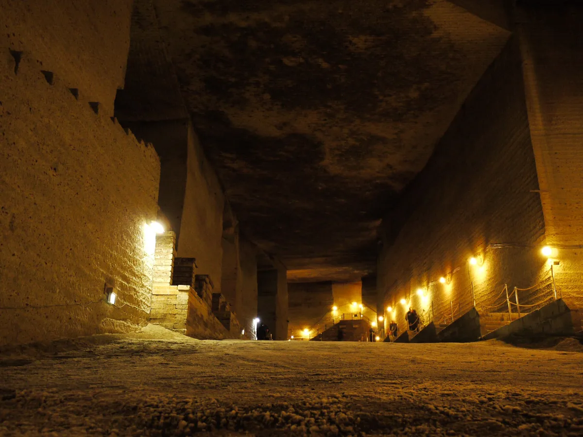 Huge underground quarry hall at the Oya History Museum, lit by small lamps along stone walls