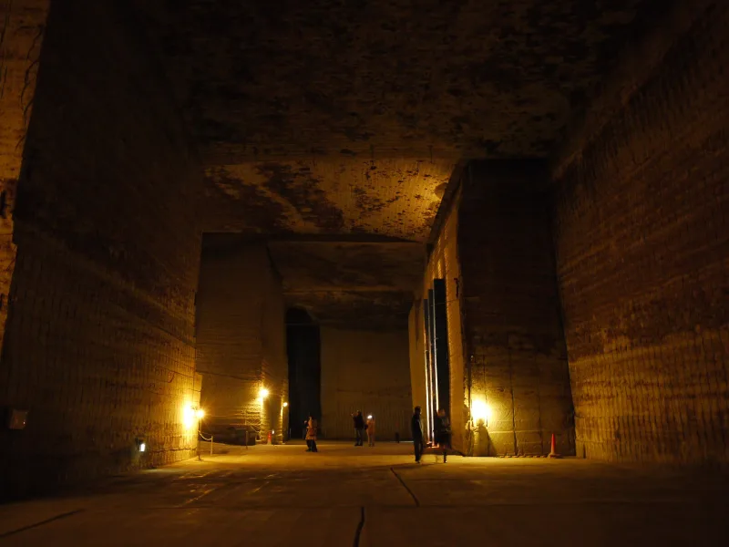 Tall square-cut stone walls and pillars inside the old Oya stone quarry