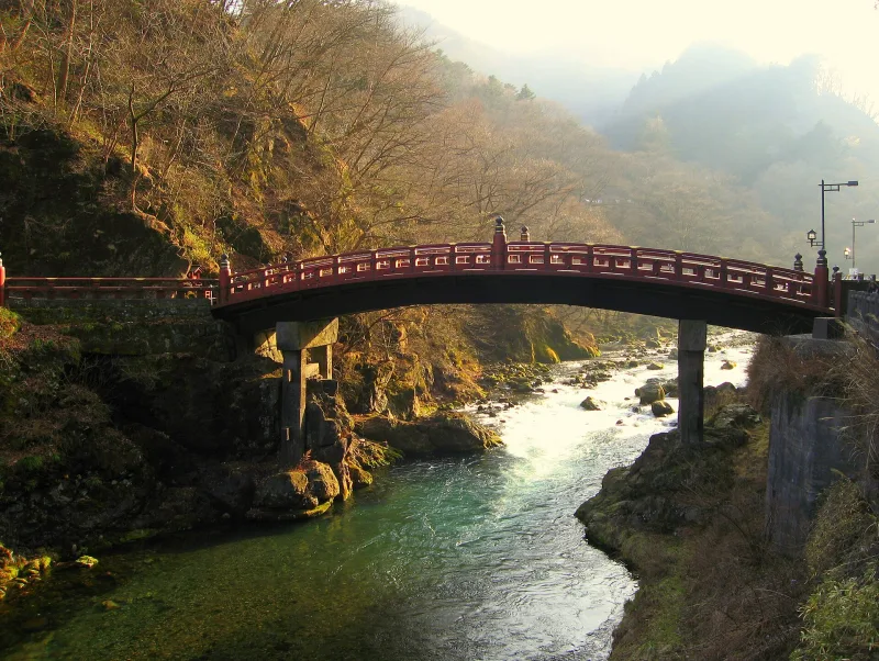 Shinkyo Bridge in autumn with coloured leaves on the gorge slopes