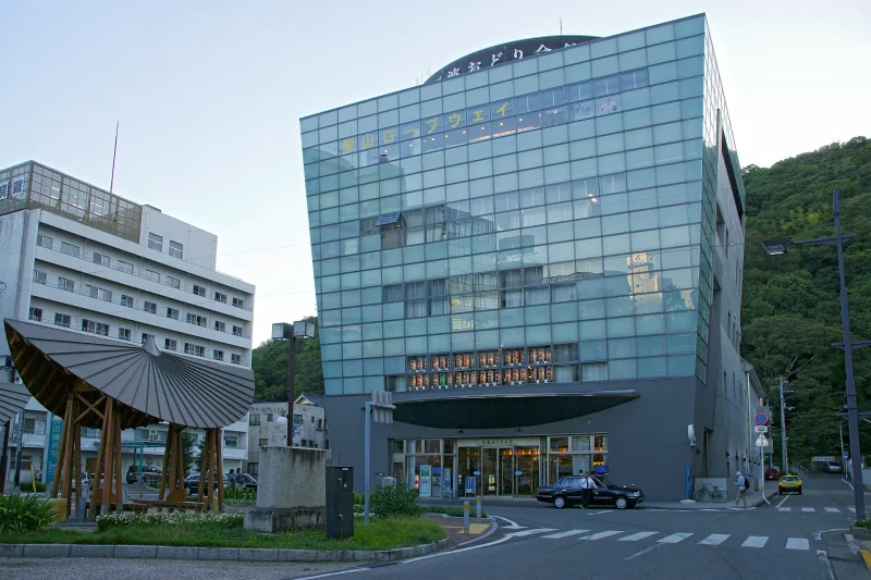 Front of the Awa Odori Kaikan building with a large sedge-hat sculpture beside the entrance