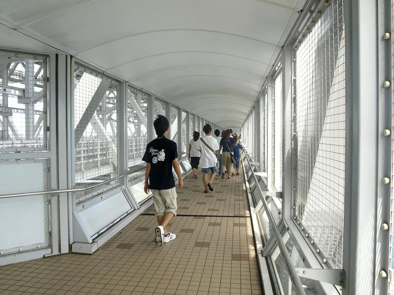The enclosed Uzu no Michi walkway inside the bridge girder, with mesh fencing on both sides