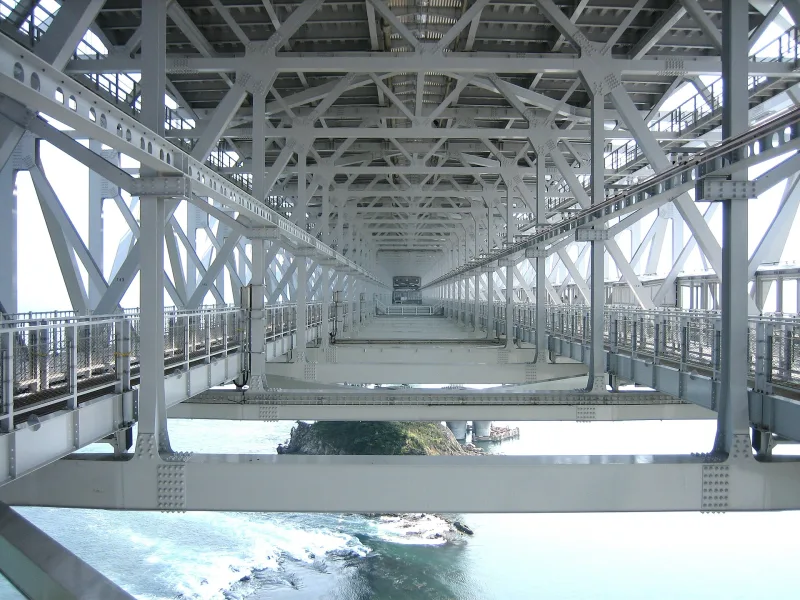 Steel framework inside the Onaruto Bridge girder, with the sea visible far below