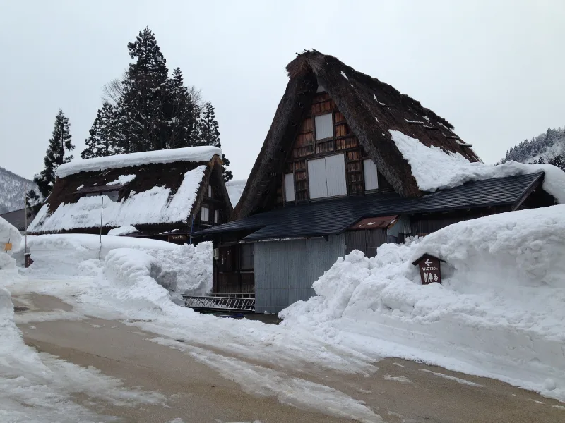 Steep thatched gassho-style house in Ainokura covered in deep snow