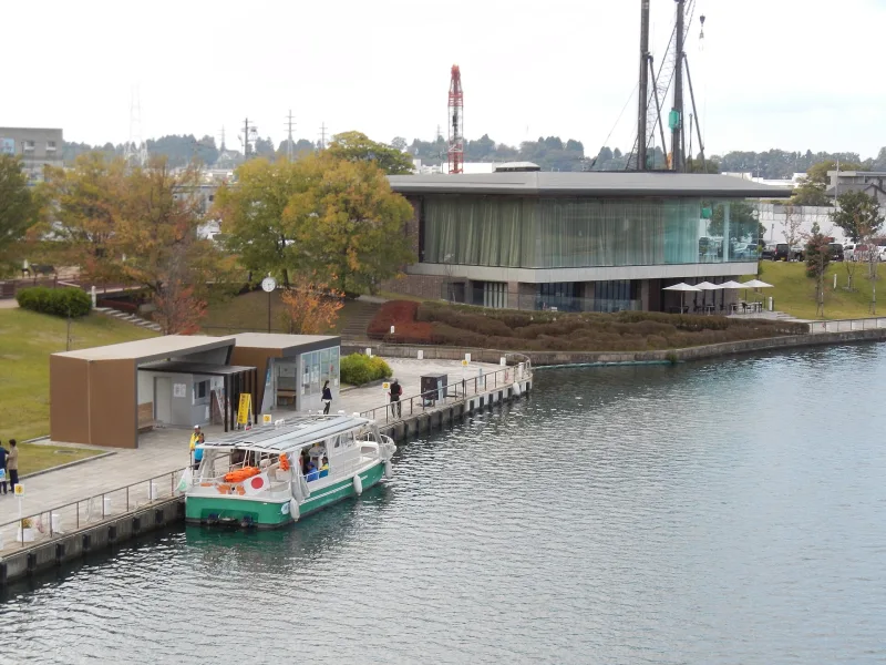 Small sightseeing boat moored at a pier on the Fugan Canal in autumn