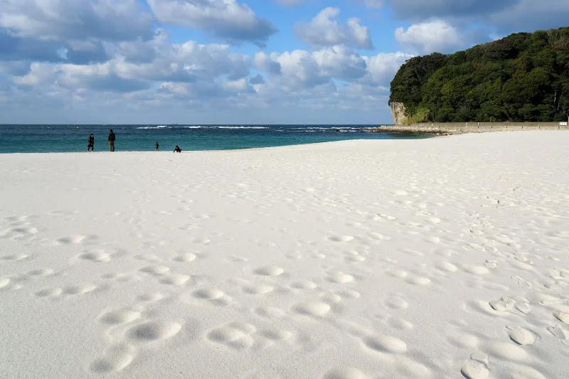 Footprints on the fine white sand of Shirarahama Beach under a blue sky