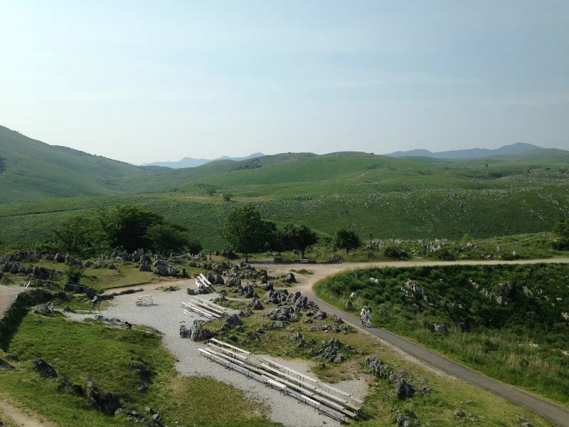 Rolling karst plateau with paths and limestone rocks, seen from the Karst Observation Deck