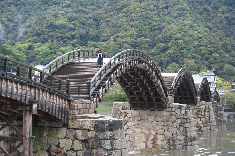 Close view of Kintaikyo's steep wooden arches rising from stone piers