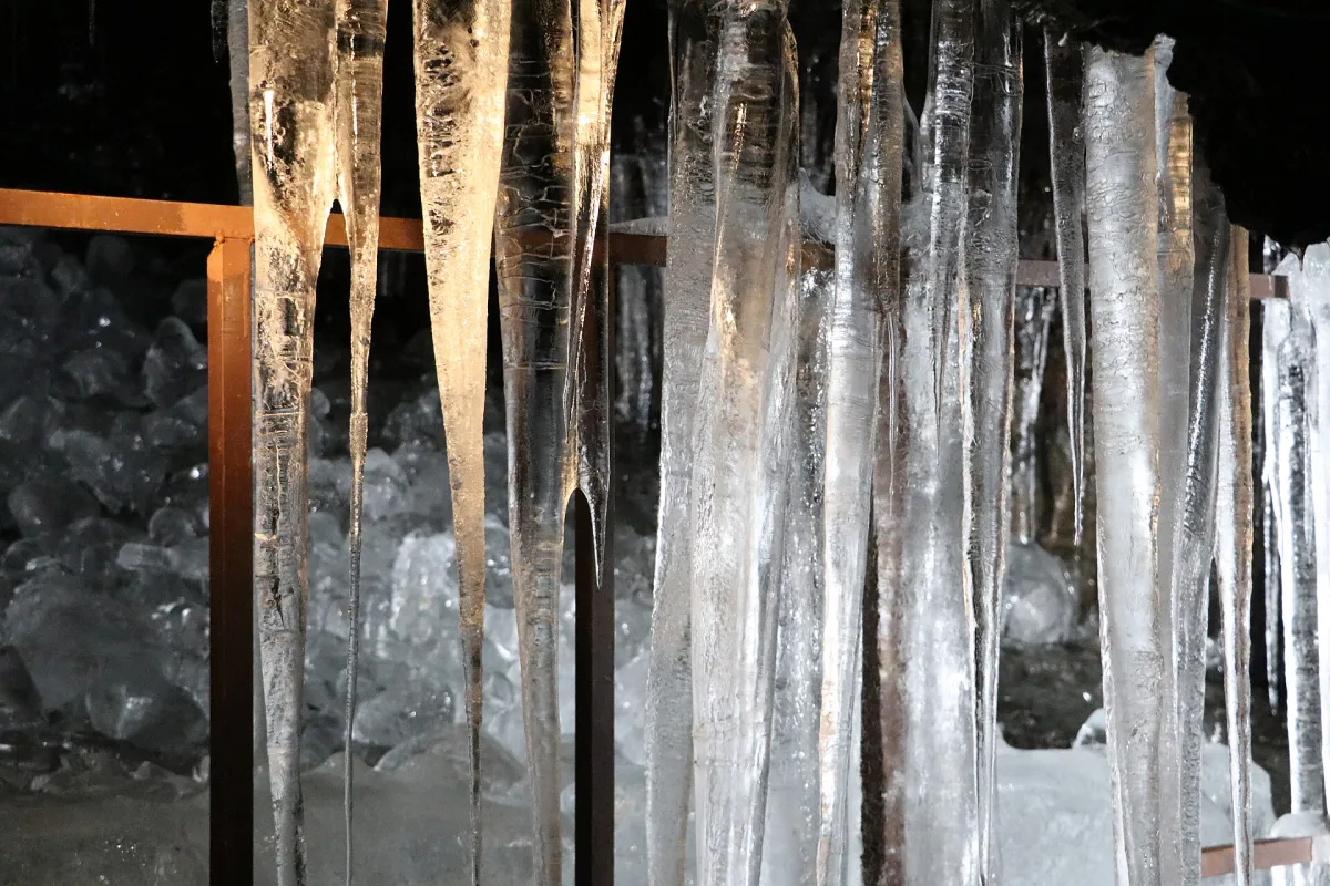 Long ice pillars hanging from the lava rock ceiling inside Narusawa Ice Cave