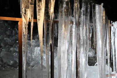 Long ice pillars hanging from the lava rock ceiling inside Narusawa Ice Cave