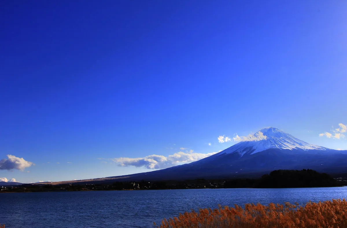 Snow-capped Mount Fuji across Lake Kawaguchi on a clear winter day, seen from the north shore